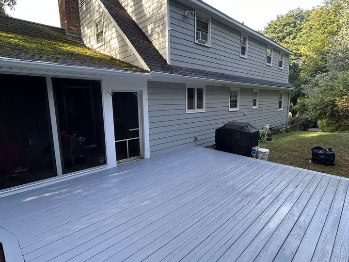 White Eagle crew painting exterior trim and soffits by hand